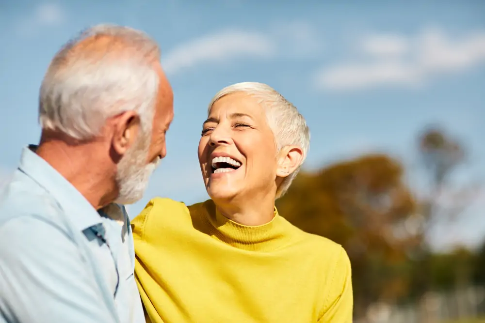 An older couple laughing together